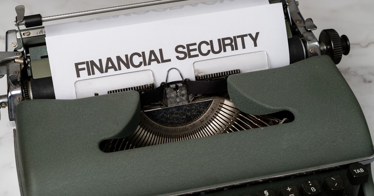 a close up of a typewriter with a financial security sign on it