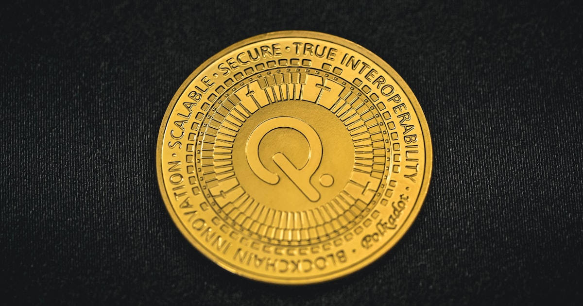 a close up of a gold coin on a black surface
