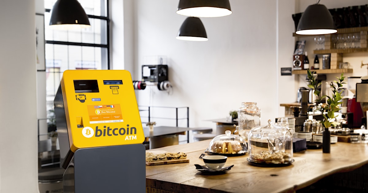 a restaurant with a large wooden counter and a yellow vending machine