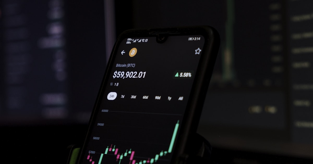 a cell phone displaying a stock chart on the screen